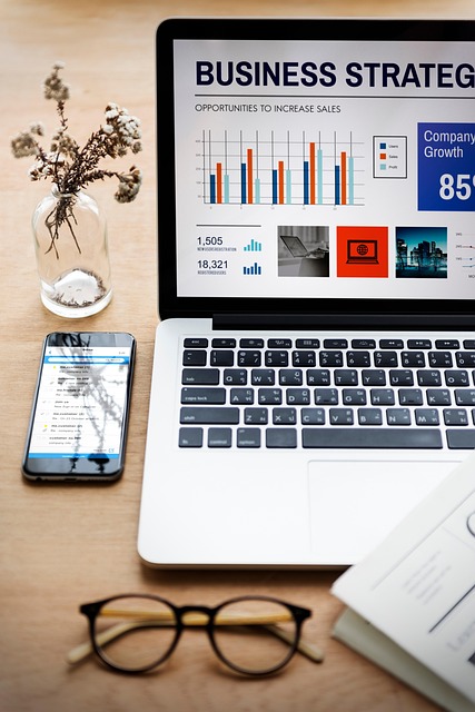 Professional workspace with laptop showing business growth analysis and strategy.